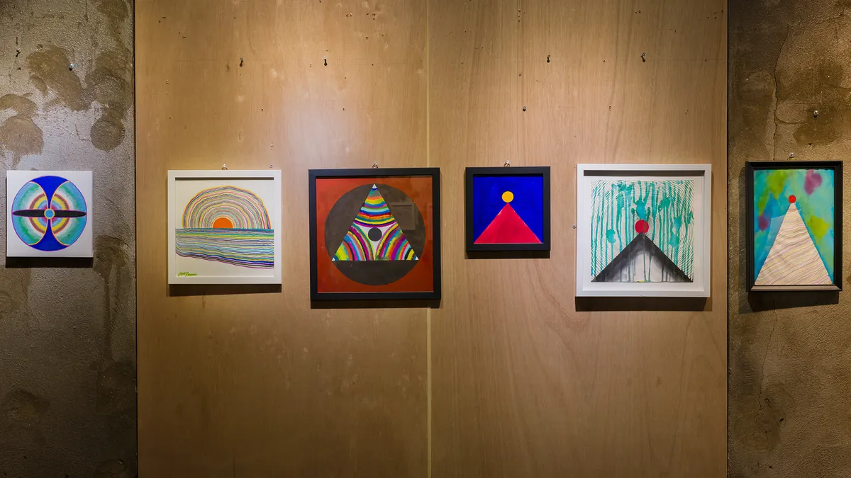 Installation view — row of works with triangle and circle motifs