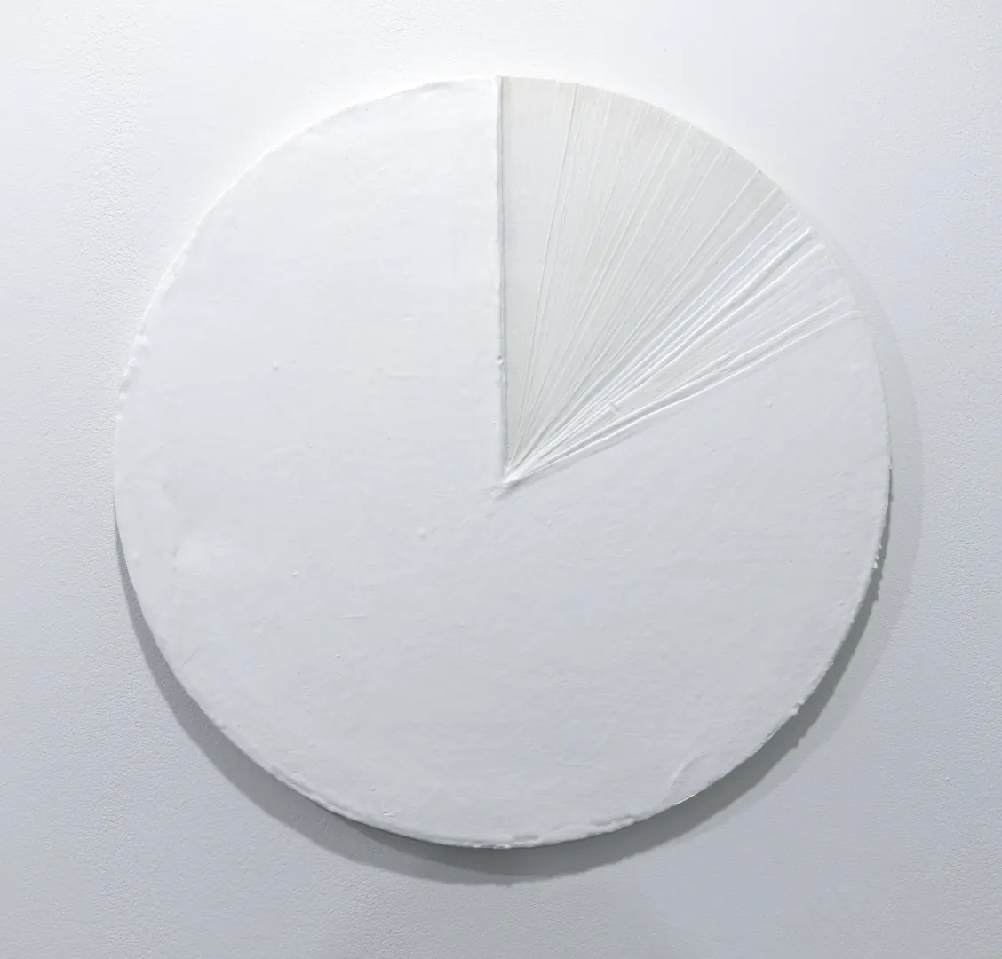 Layers of Gesso — a white circular surface, mostly smooth, with one wedge built from raised radiating gesso lines